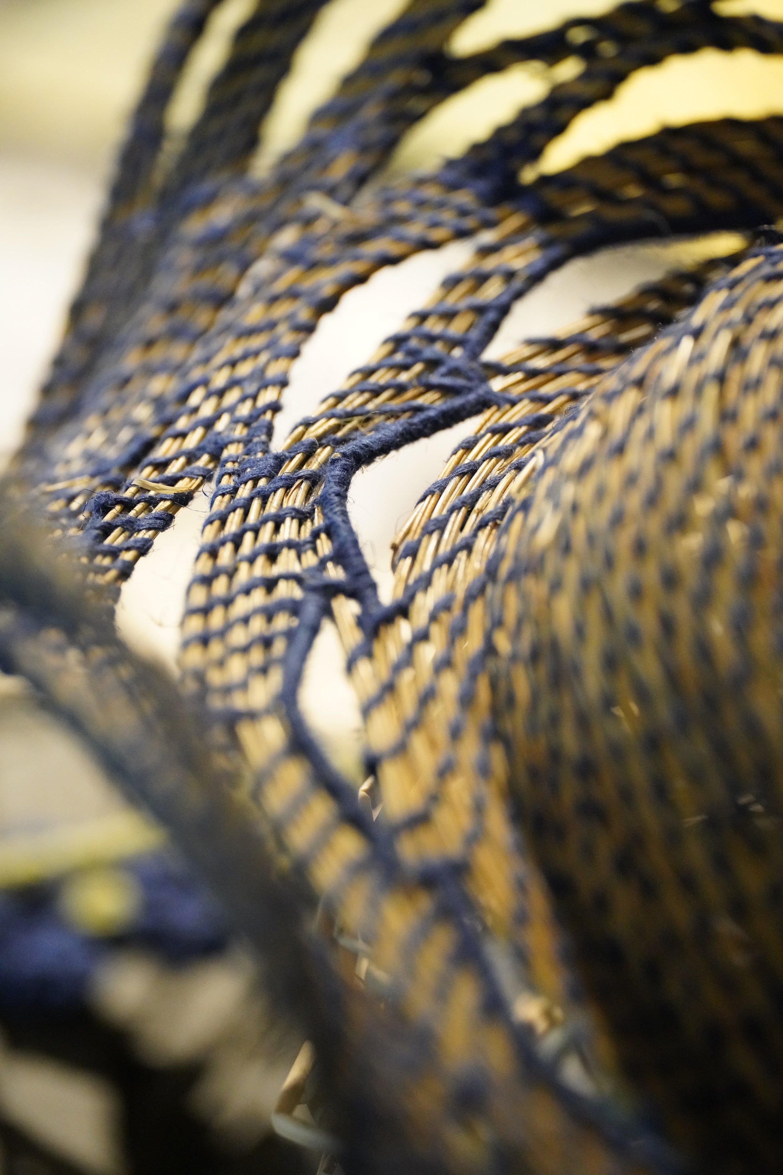 Close up of the TABERNAS hat, meticulously woven using ancestral techniques with dry branches sourced from the mountains of Southern Spain and blue pineapple yarn.